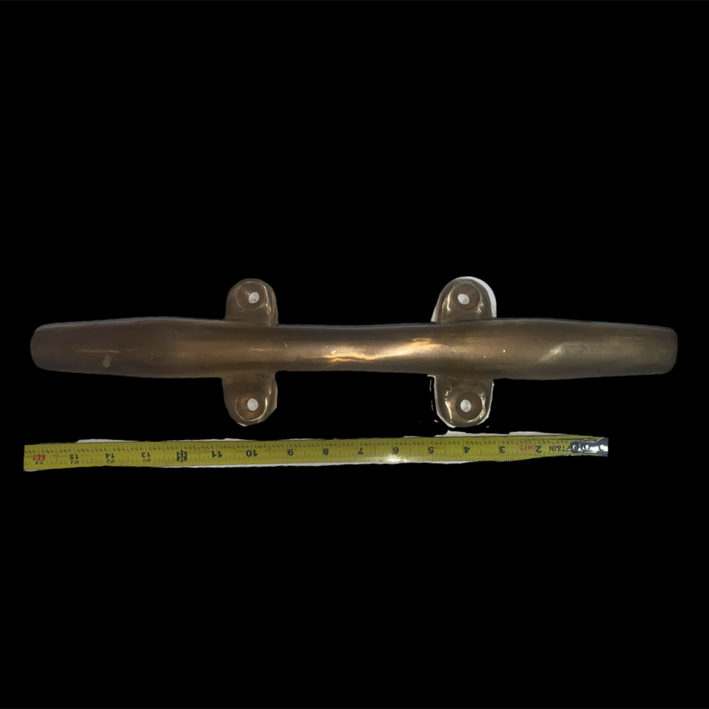 Metallic handle with a measuring tape for scale on a black background