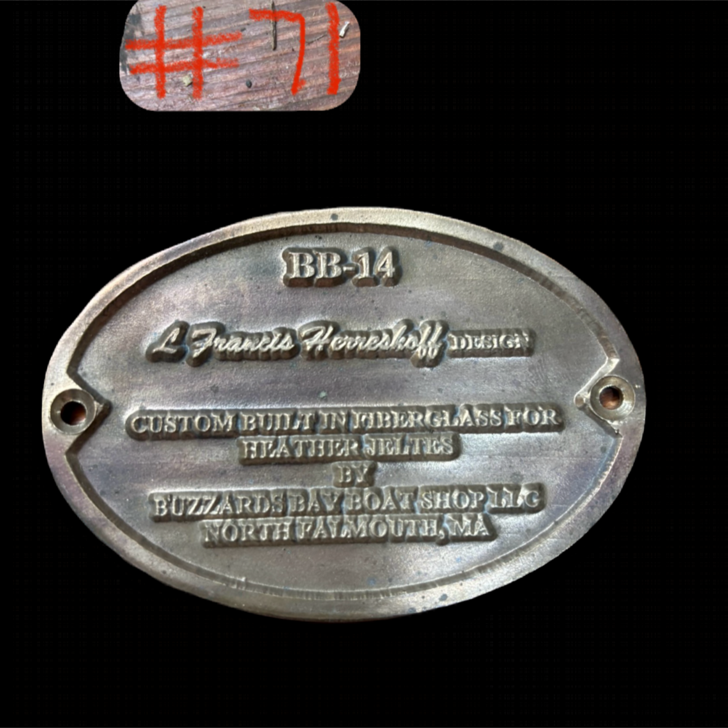 Metal plaque with engraved text on a black background