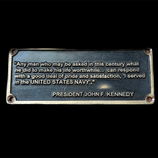 Metal plaque with engraved text on a black background