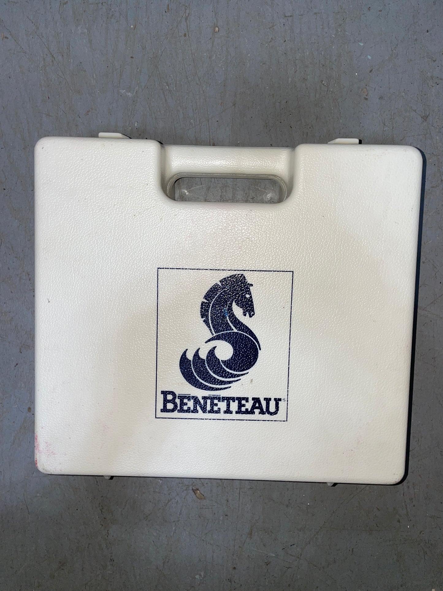 White box with Beneteau logo on a gray surface