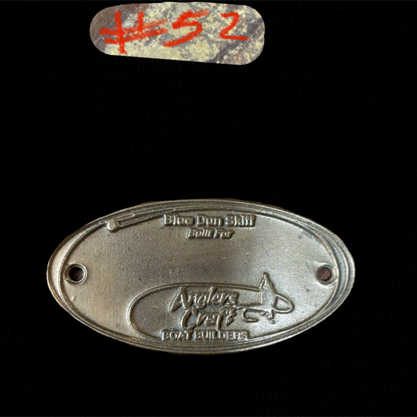 Metal plaque with 'Anglers Craft' branding on a black background