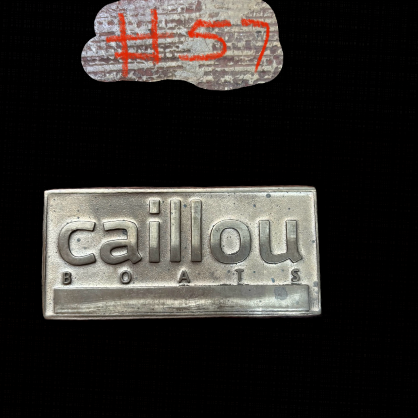 Metallic 'caillou boats' logo with '#57' above on a black background