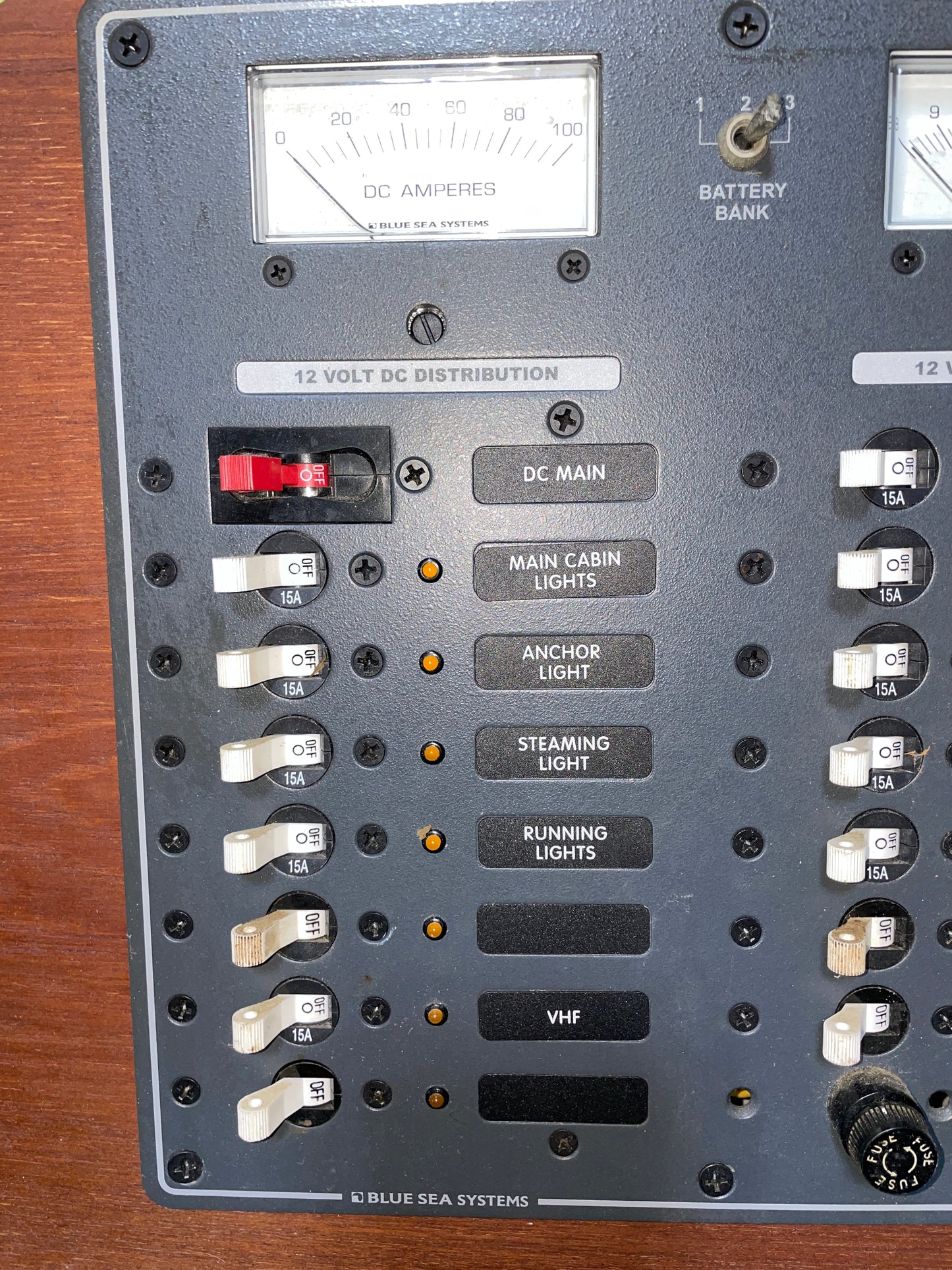 Control panel with switches and indicators on a wooden surface