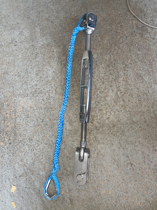 Metal strap with blue rope on a concrete surface