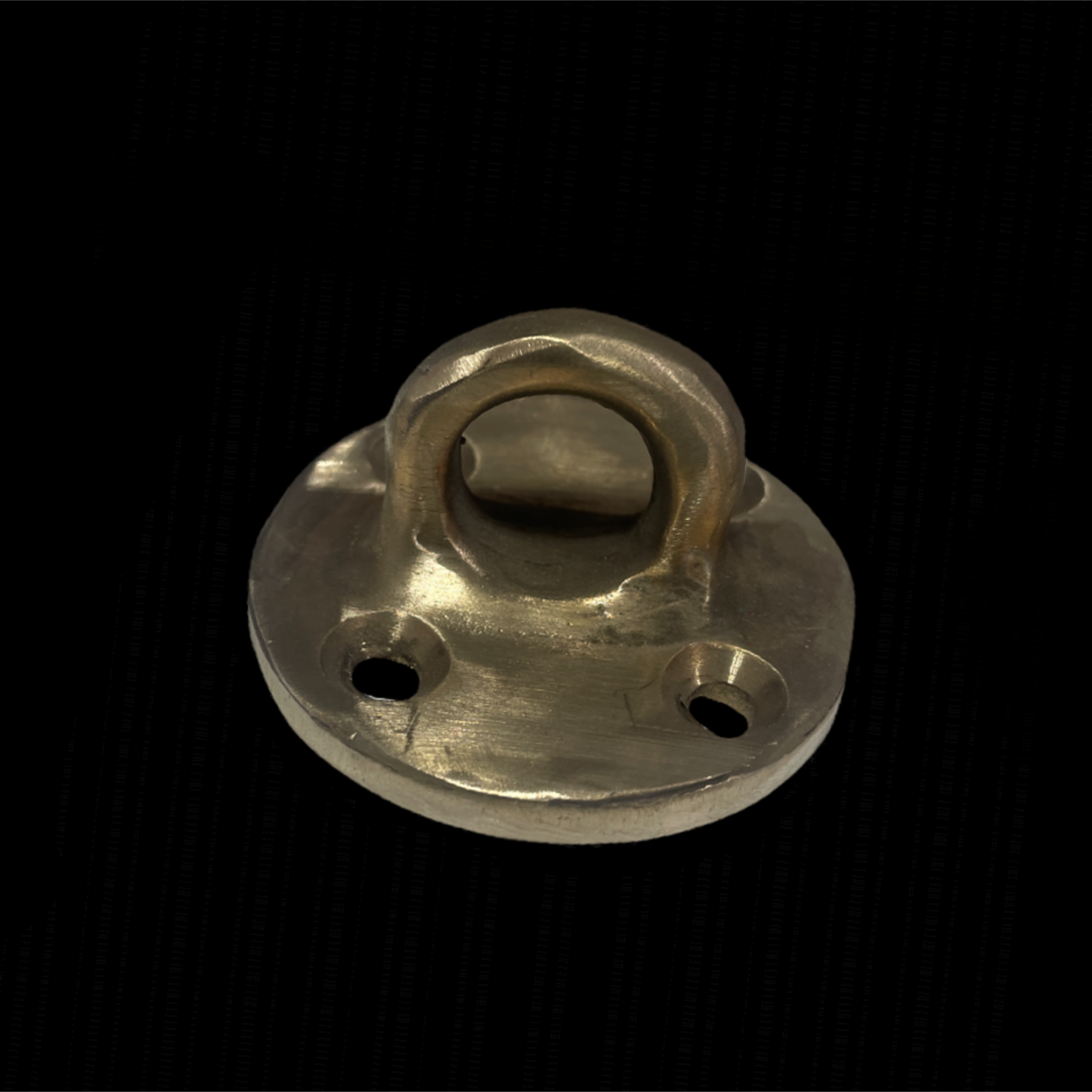 Metallic door knocker on a black background