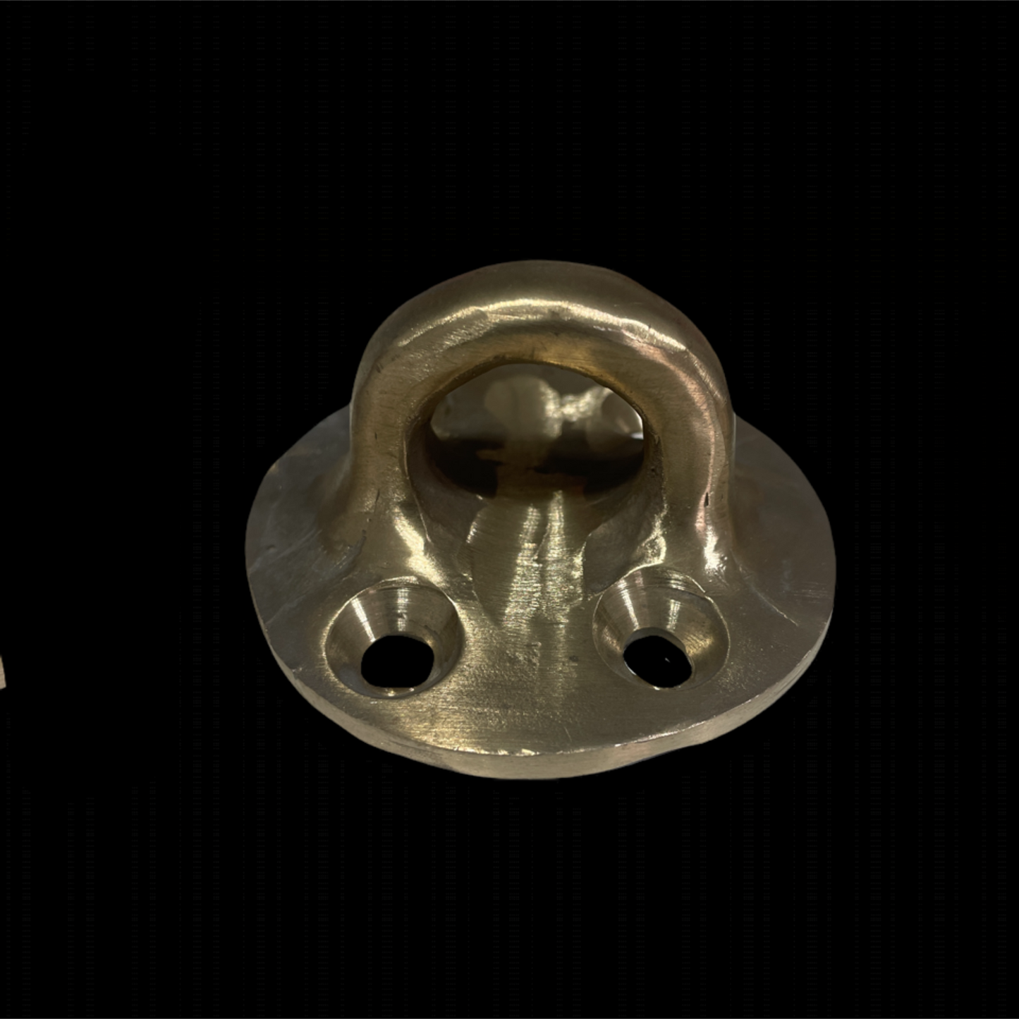 Brass door knocker on a black background