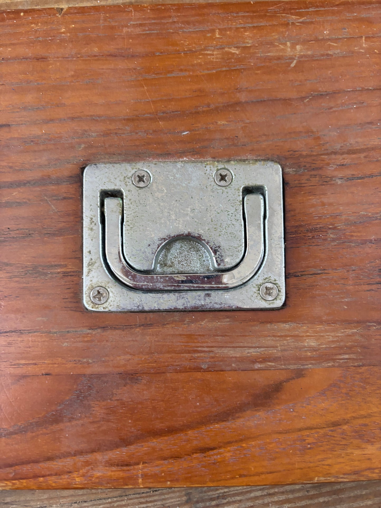 Metal latch on a wooden hatch