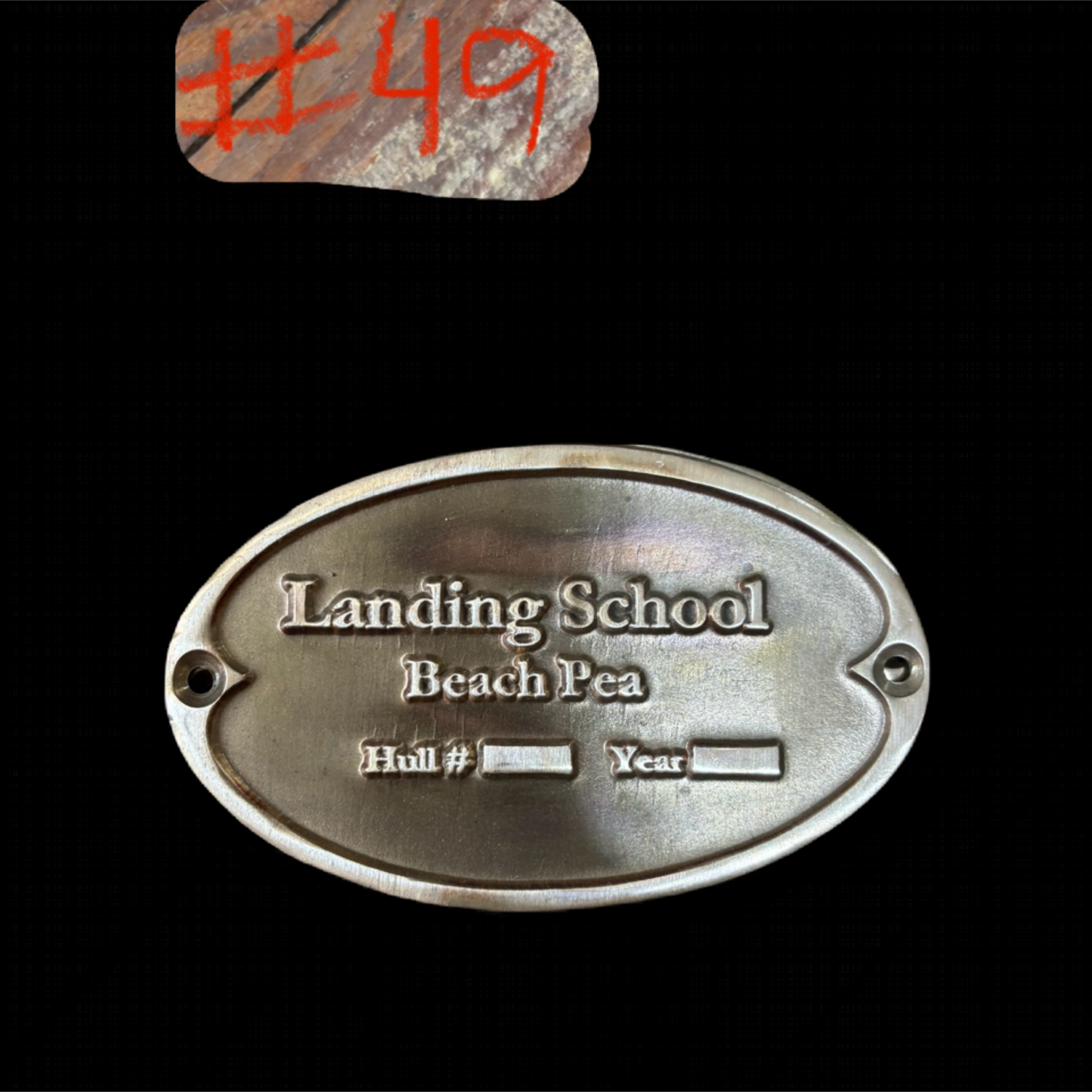 Metal plaque with engraved text on a black background