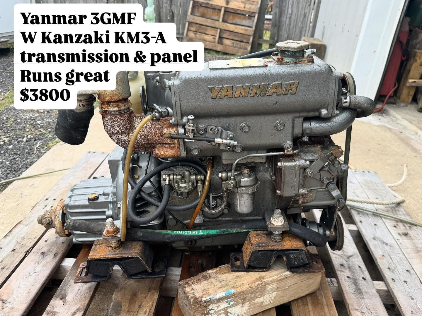 Yanmar 3GMF engine with Kanzaki KM3-A transmission on a wooden pallet.