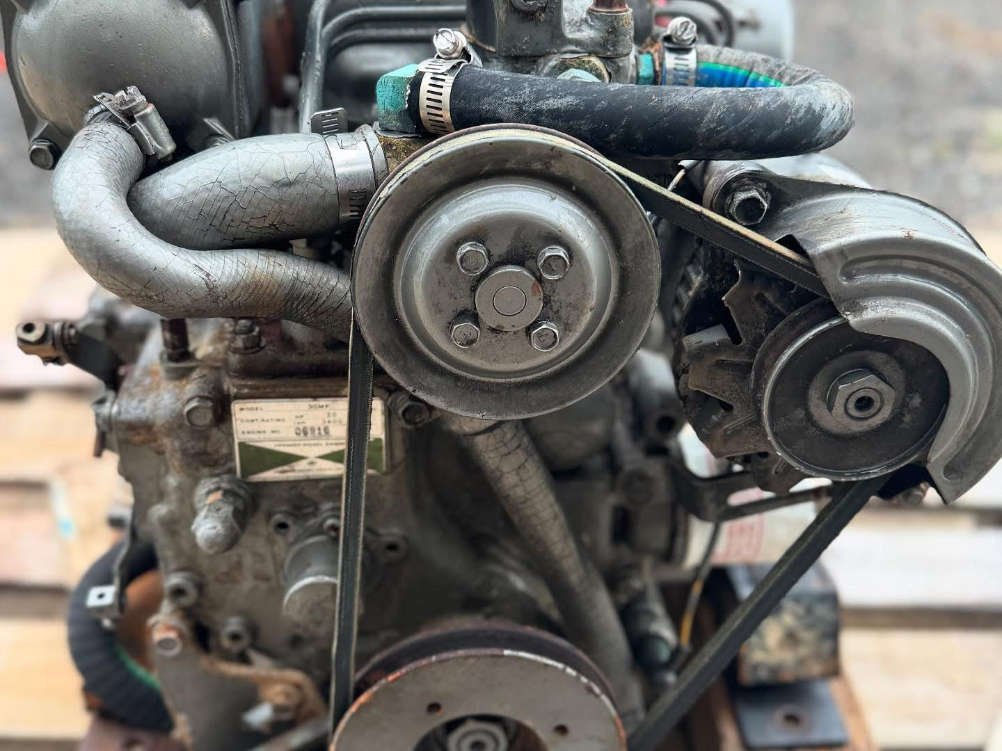 Close-up of an engine with belts and pulleys