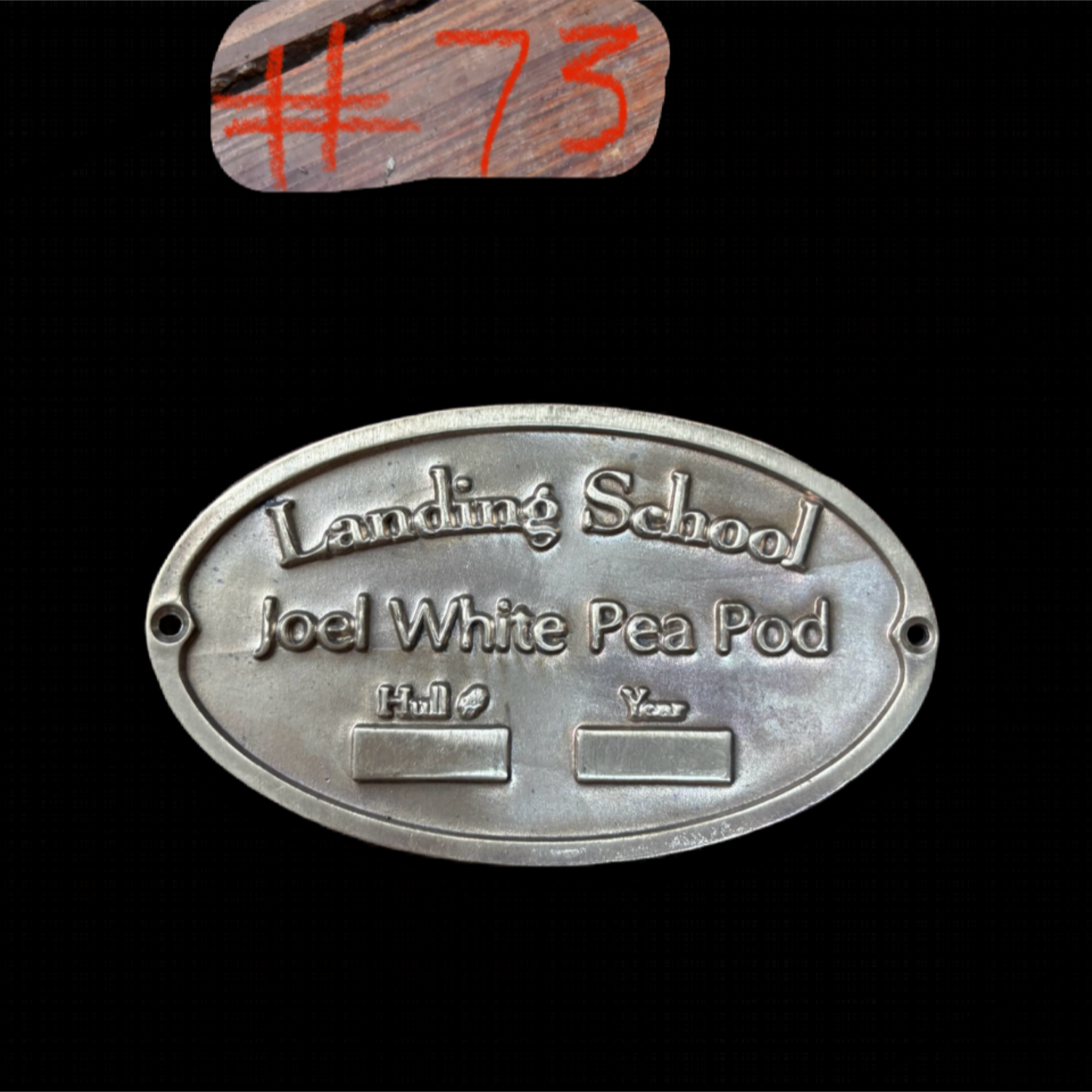 Metal plaque with engraved text on a black background