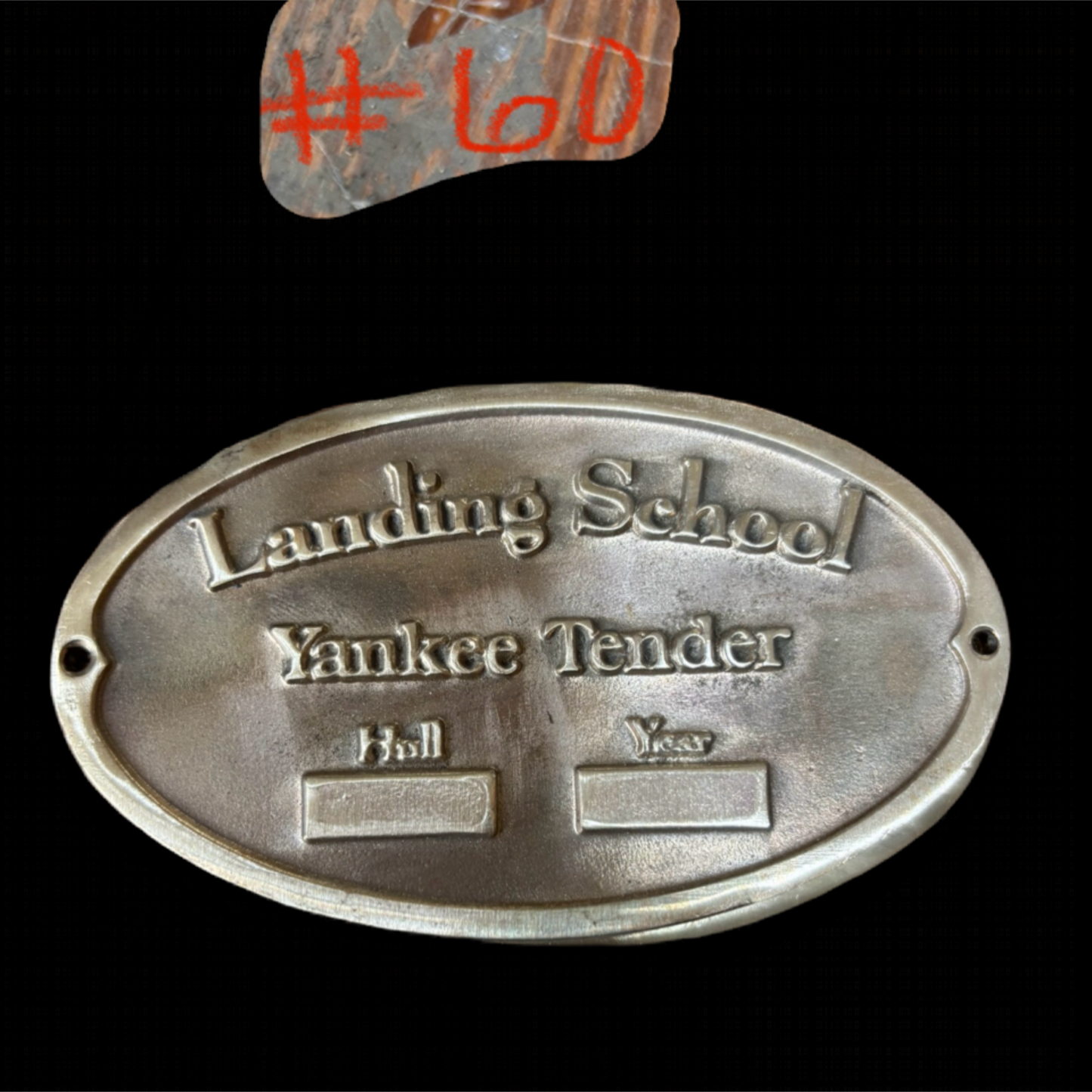 Metal plaque with engraved text on a black background