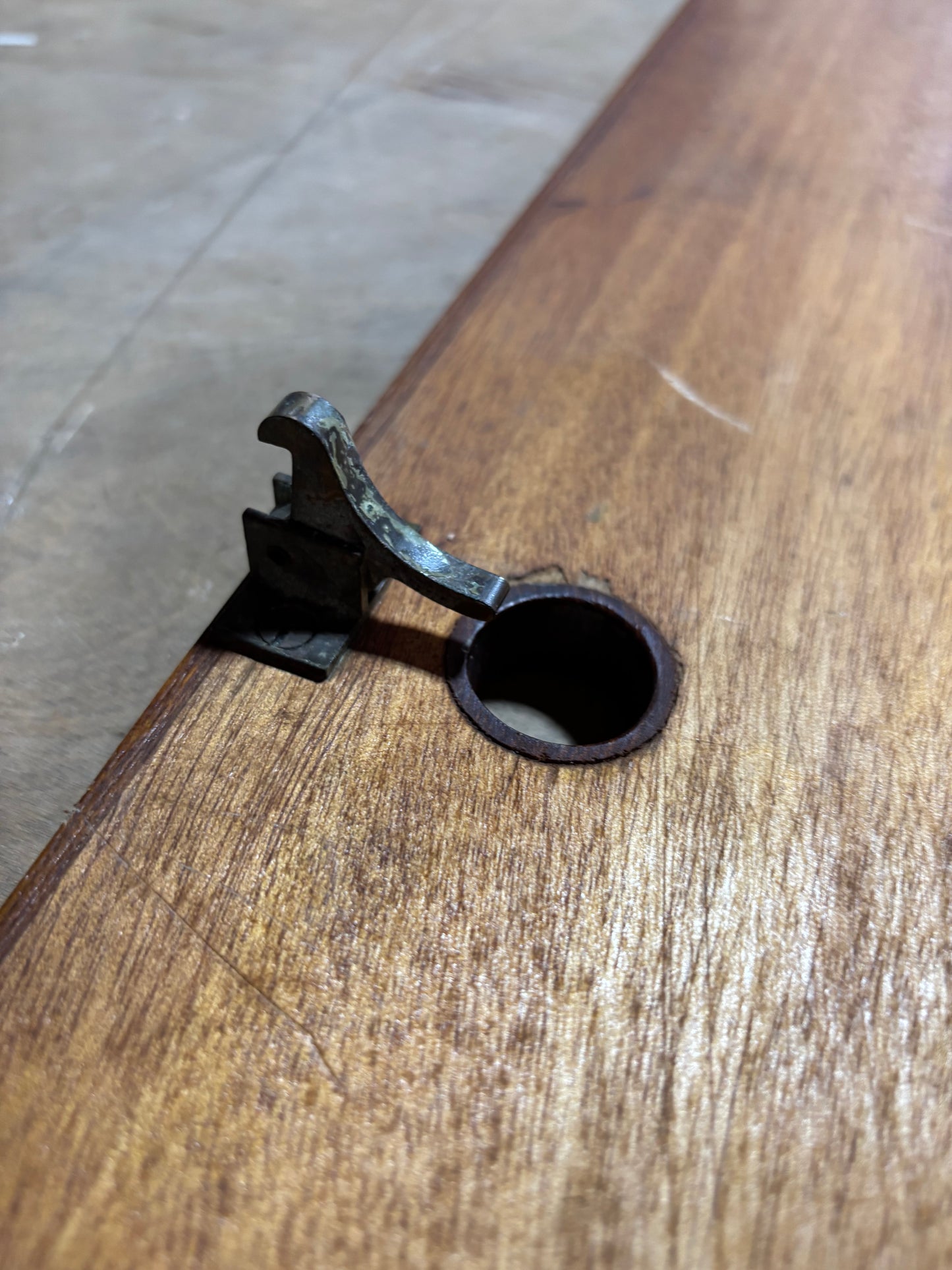 Metal clip attached to a wooden surface