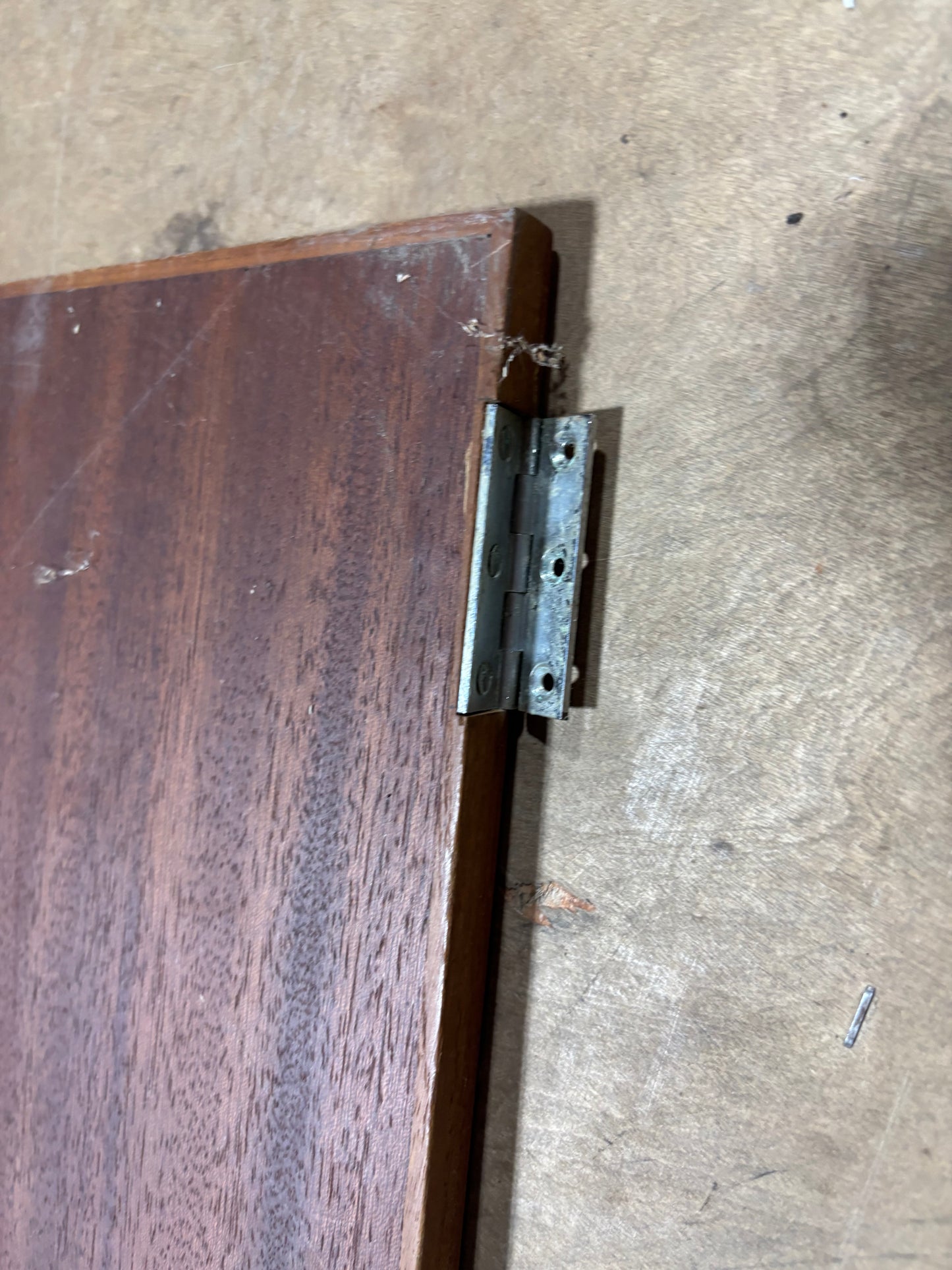 Metal hinge on a wooden surface
