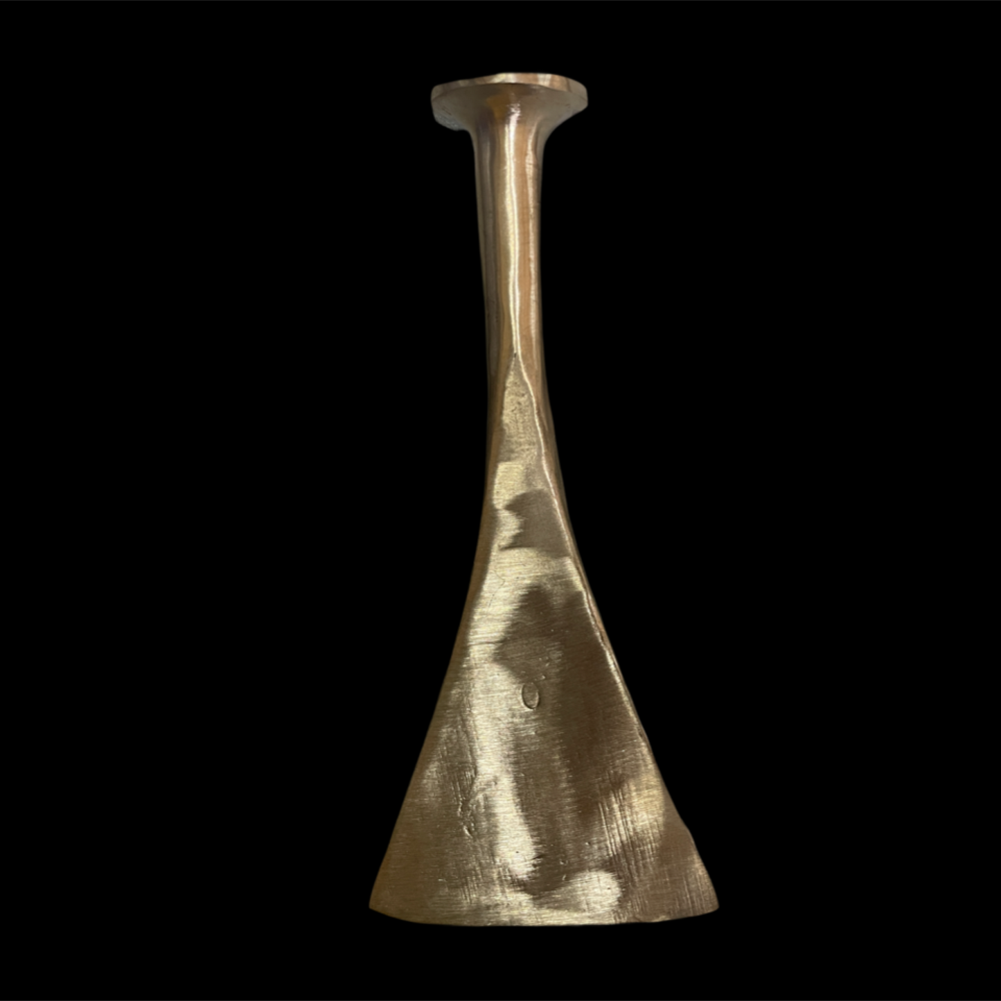 Gold vase with a textured surface on a black background