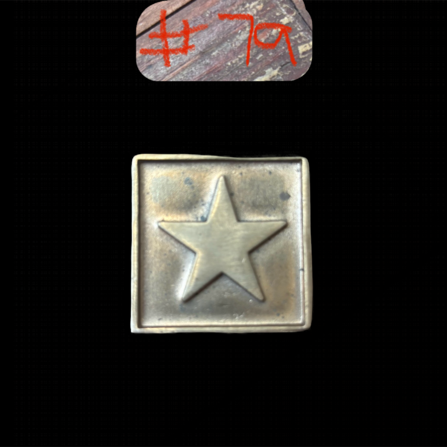 Metallic star emblem on a black background with red text above