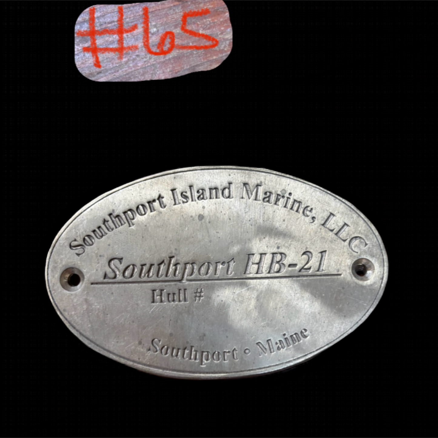 Metal plaque with 'Southport Island Marine, LLC' text on a black background