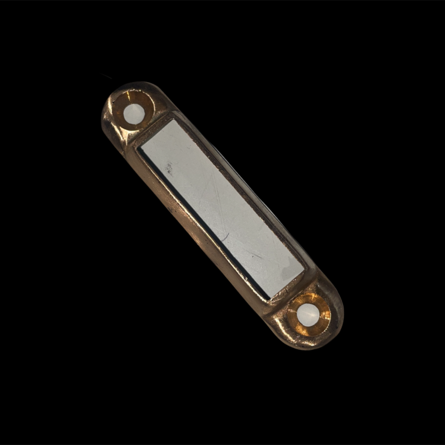 Gold-framed rectangular object with a white center on a black background