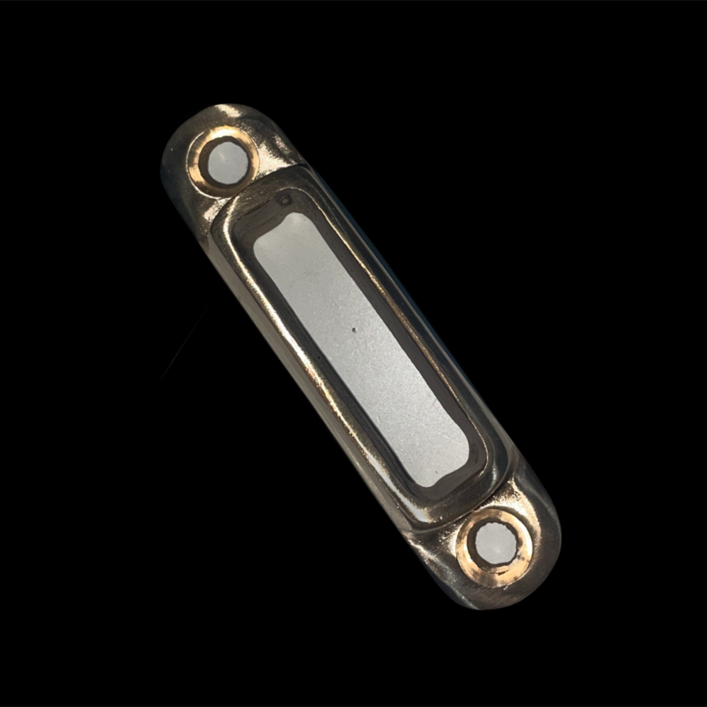 Metallic rectangular object with rounded corners on a black background