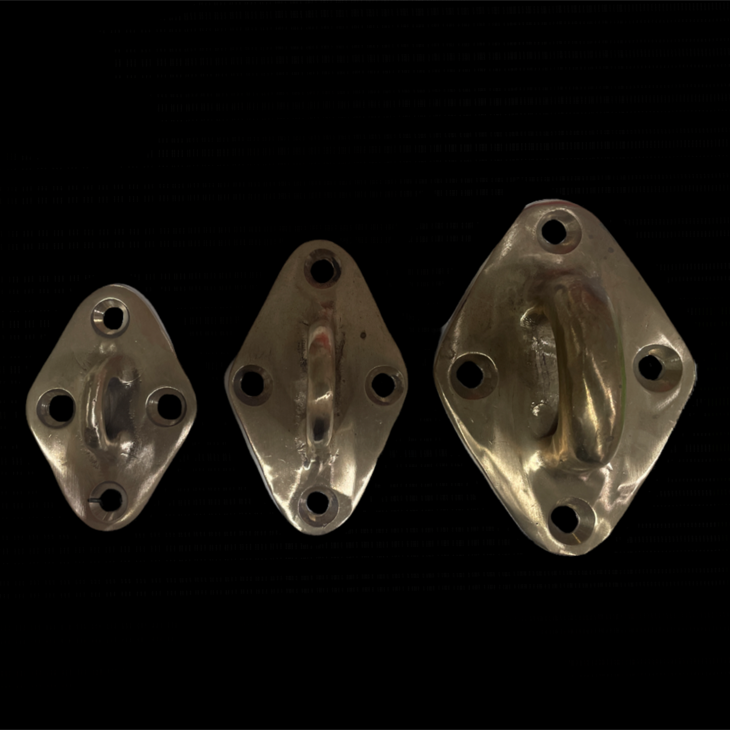 Three metal wall hooks on a black background