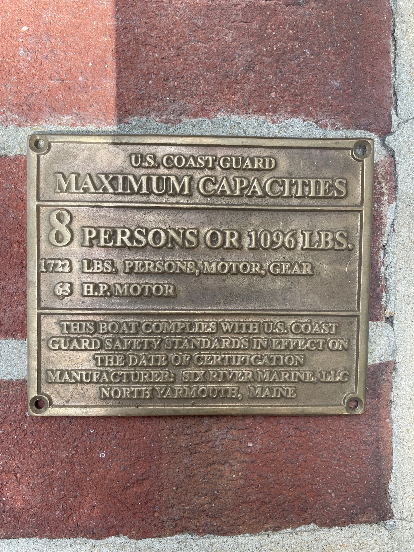 Brass plaque with text on a stone surface