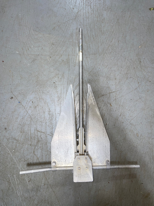 Metal tool with prongs on a textured gray surface