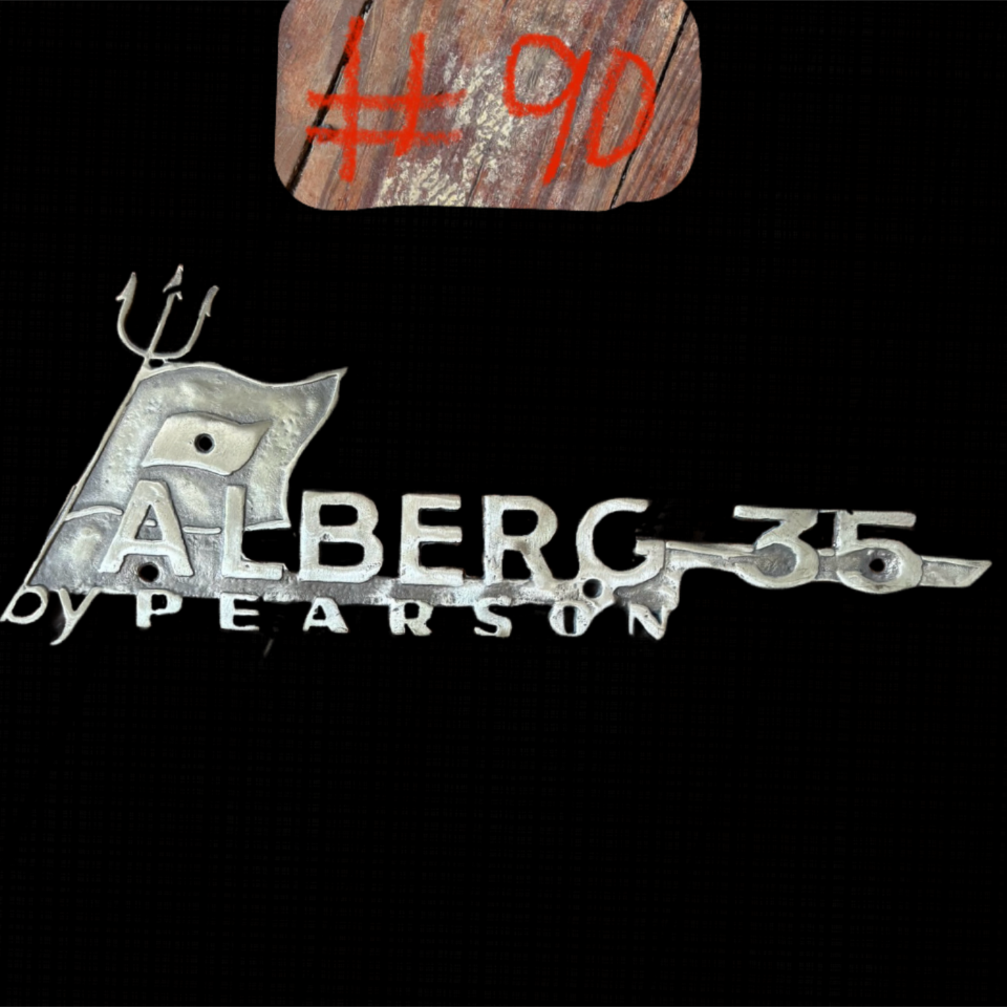 Metallic logo with 'Alberg by Pearson' text on a black background