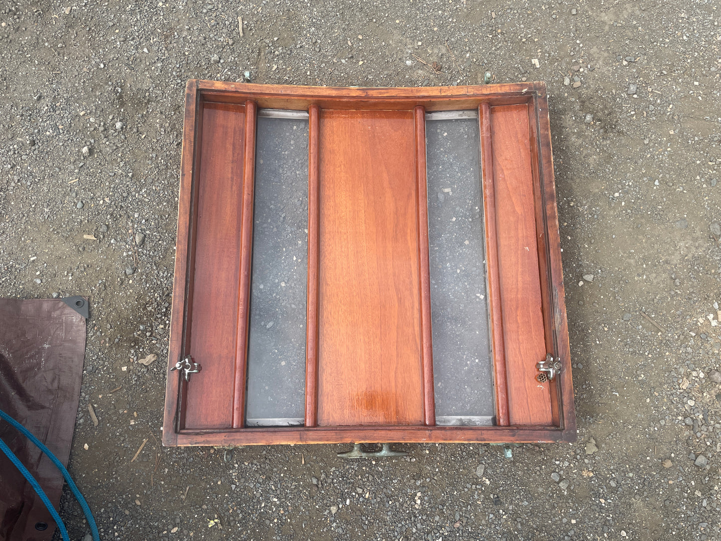 Wooden box with metal components on a concrete surface