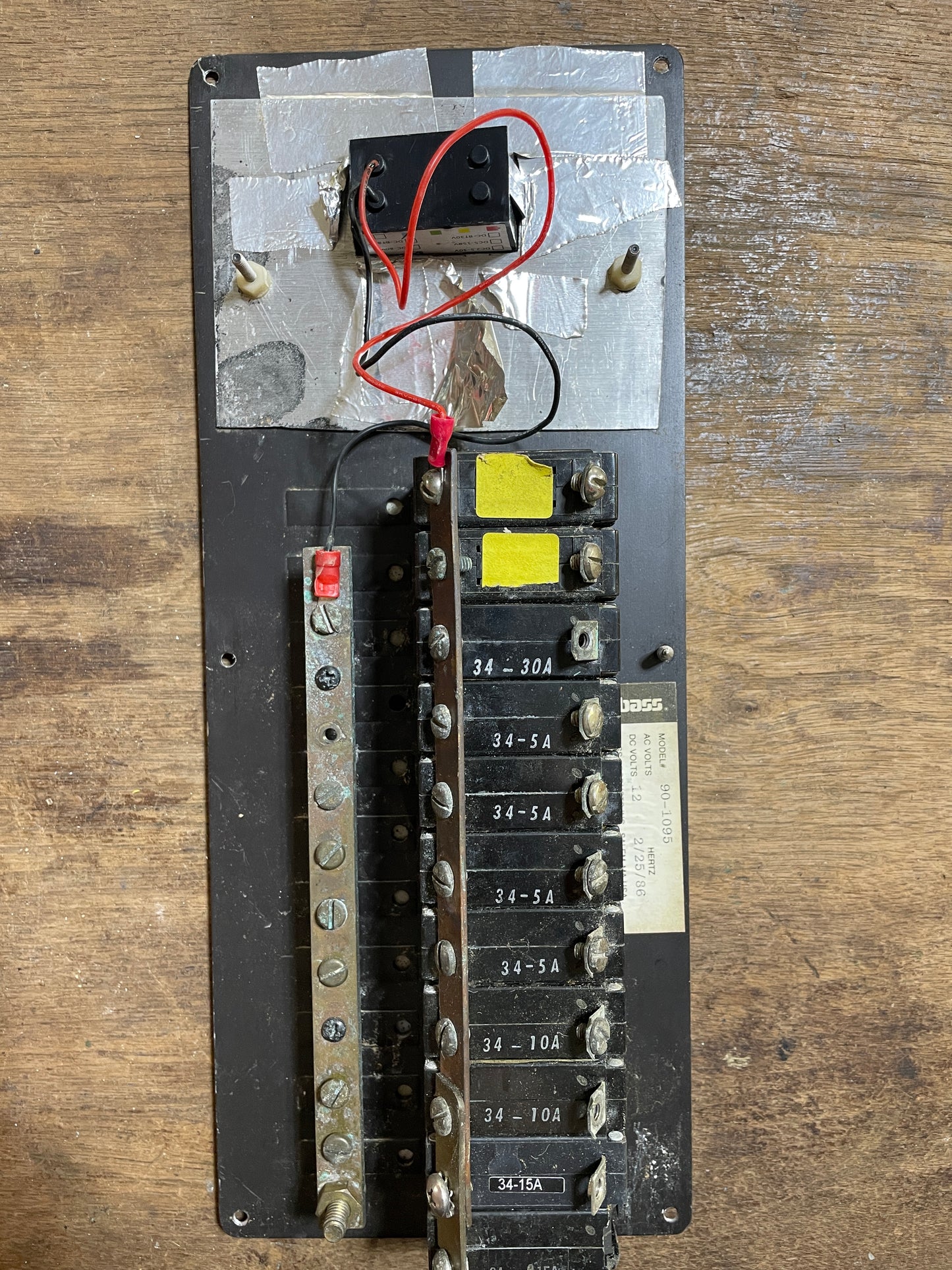 Electrical panel with wires and components on a wooden surface