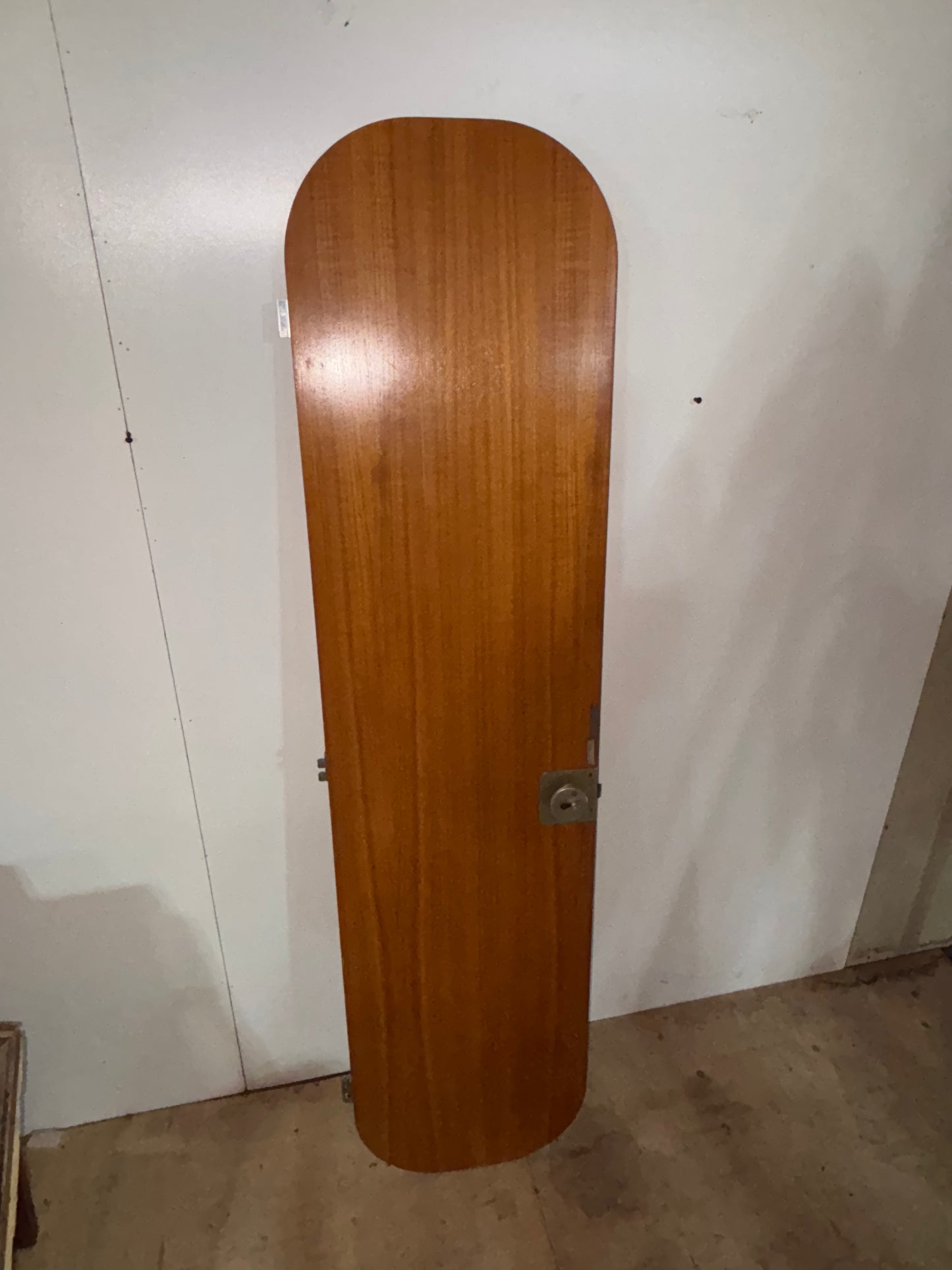 Wooden door against a white wall