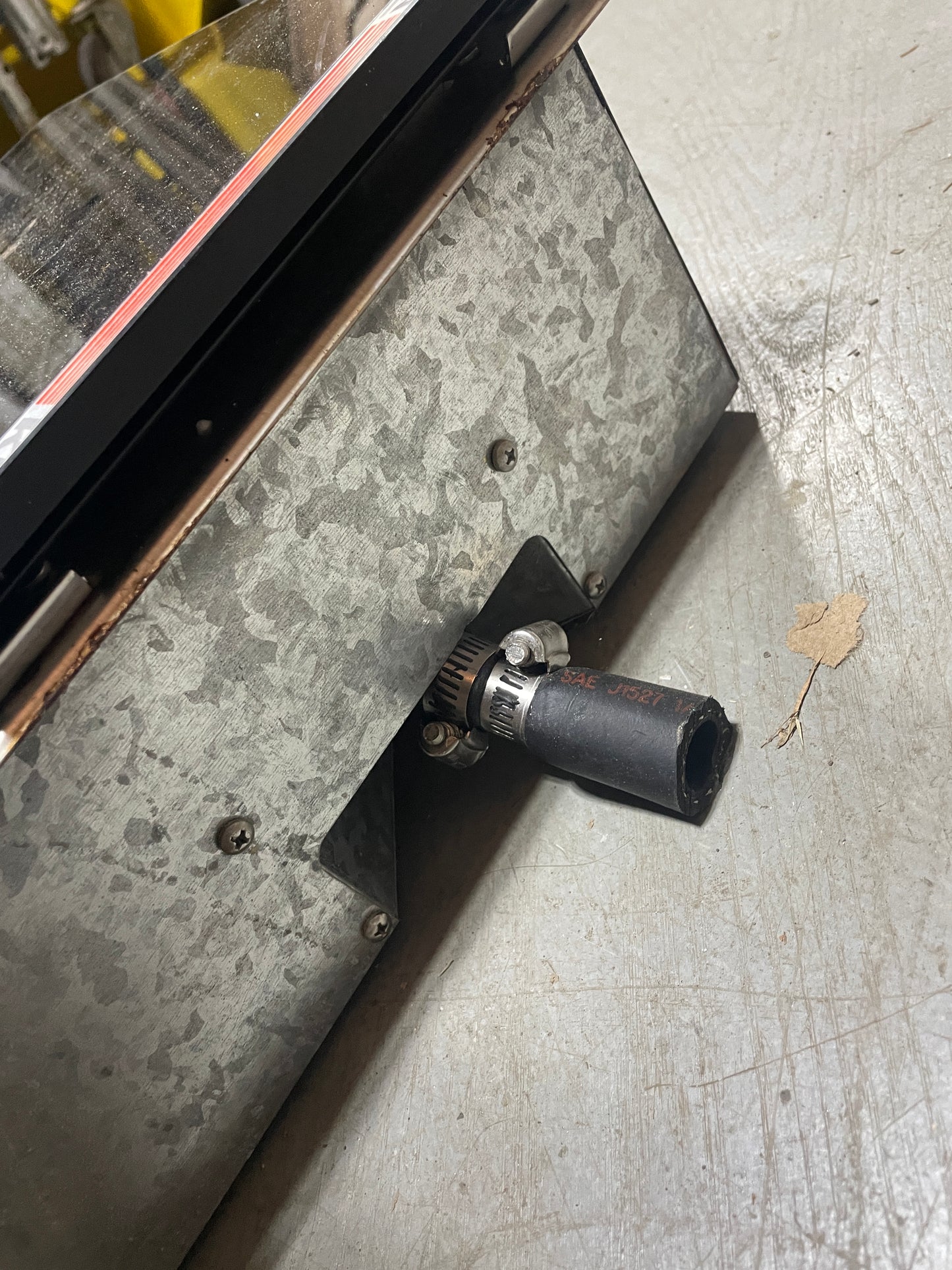 Metal drill bit on a metal surface with a leaf