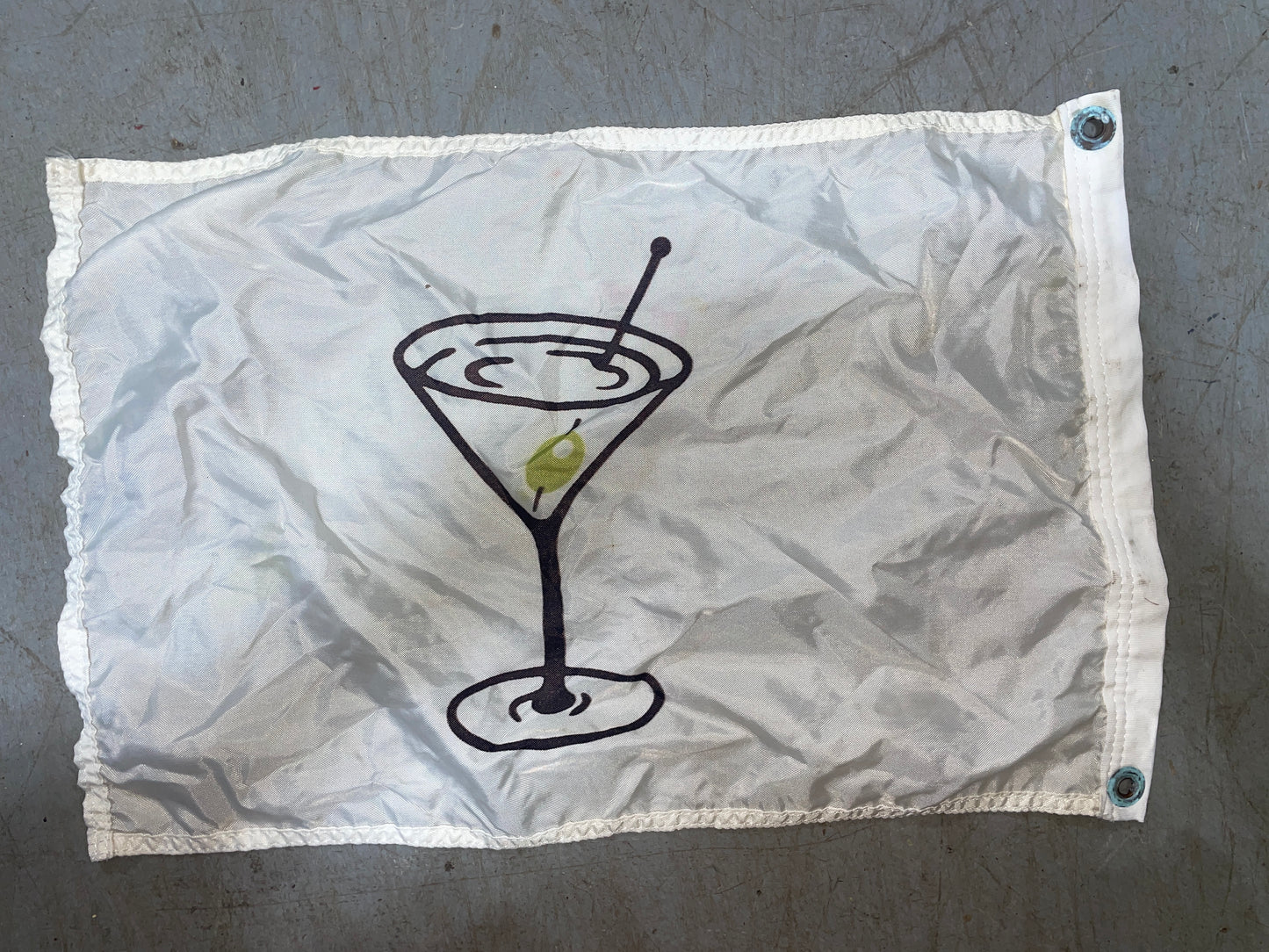 Fabric pouch with a martini glass illustration on a gray background
