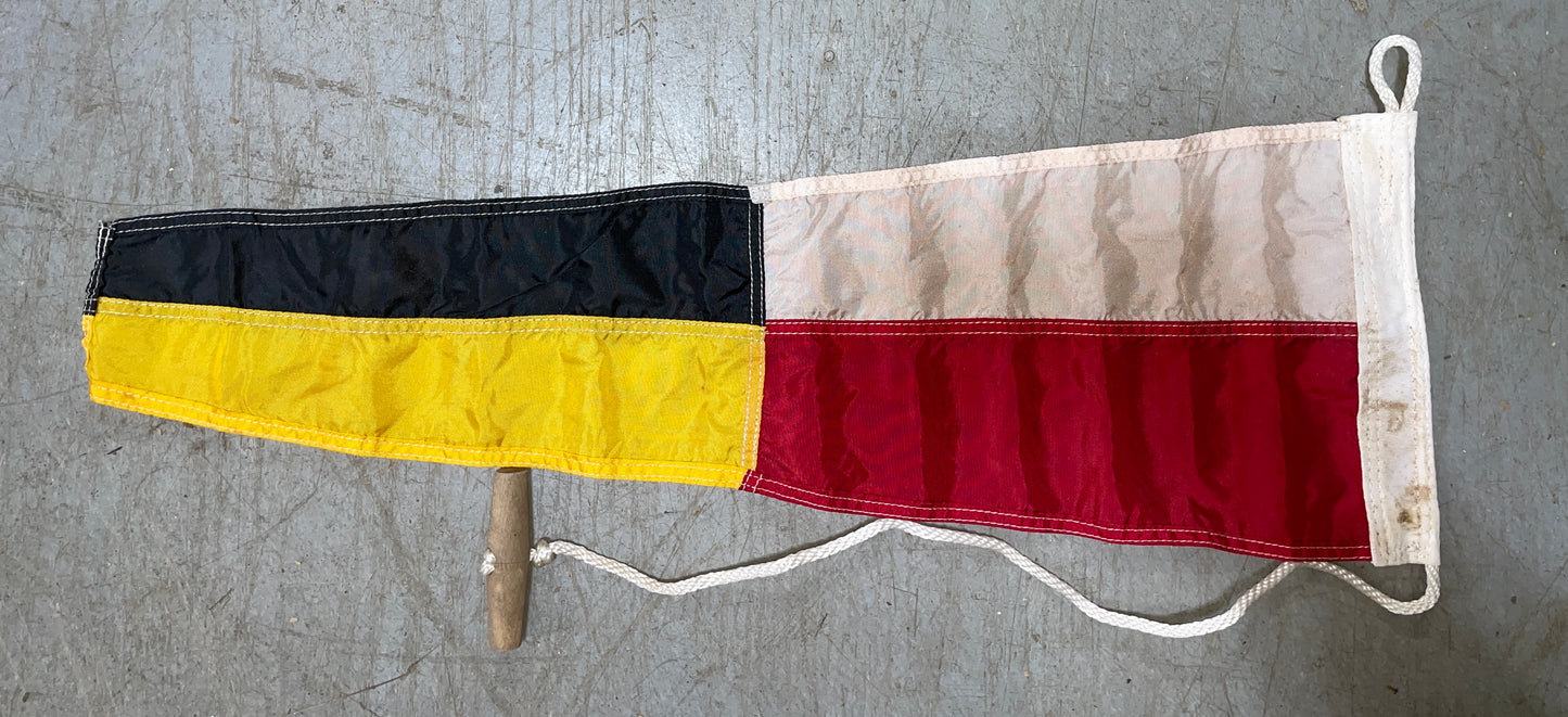 Flag with black, yellow, and red stripes on a gray background