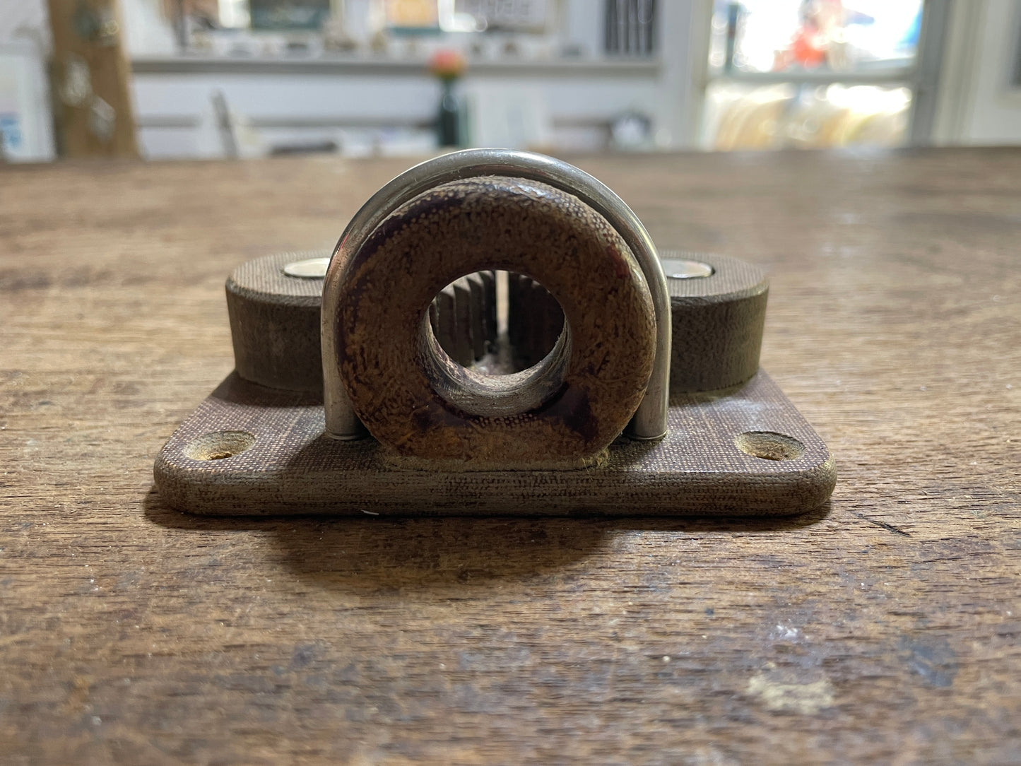 Mechanical bearing on a wooden surface with a blurred background