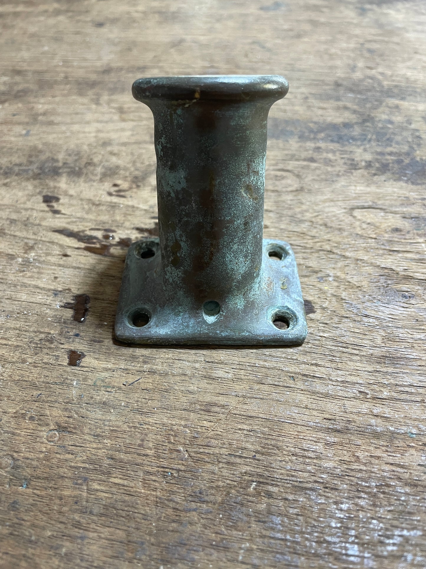 Metal bracket on a wooden surface