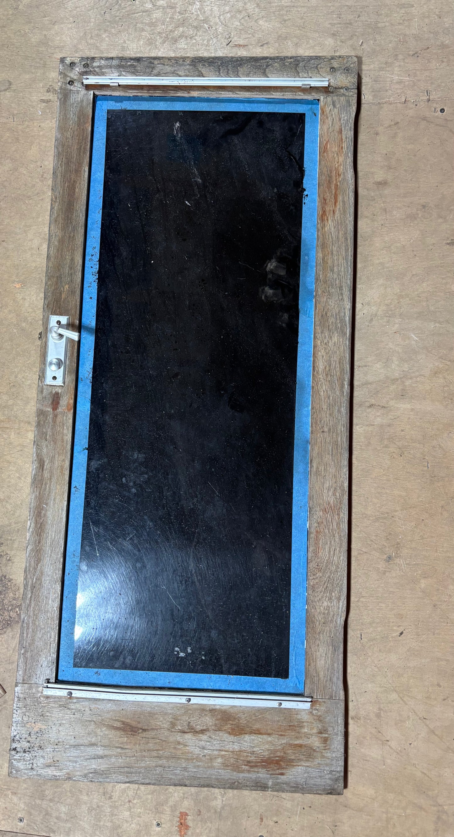 Wooden door with a glass panel on a beige background