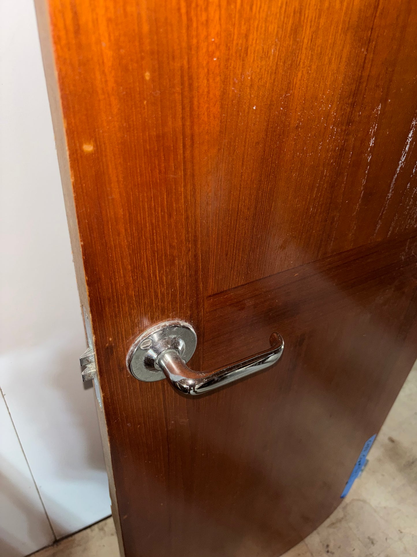 Wooden door with a metallic handle and lock