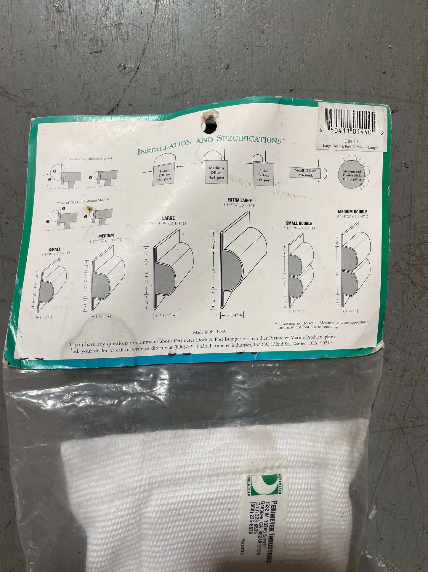 White fabric with a green label and instructions on a gray surface