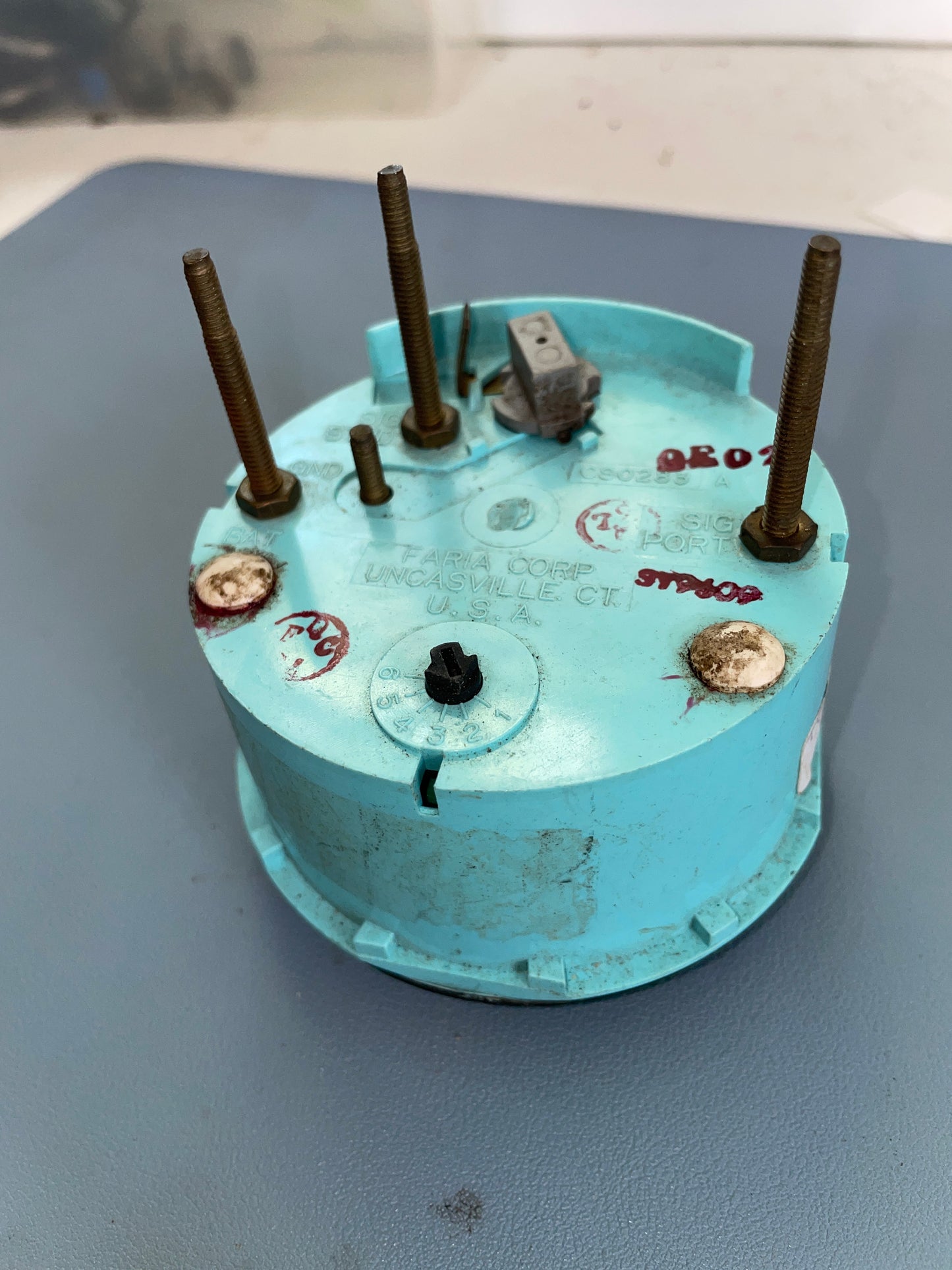 Old electrical plug with visible wear on a gray background