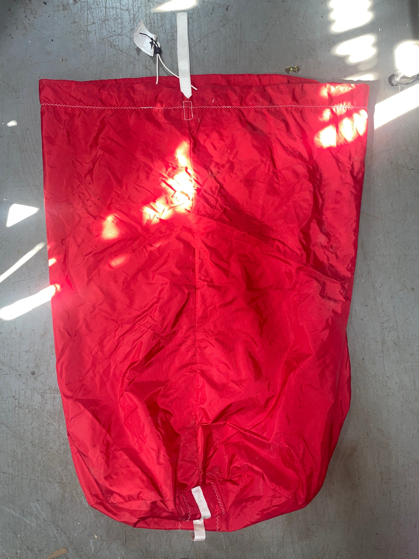 Red flag with visible wear on a gray surface