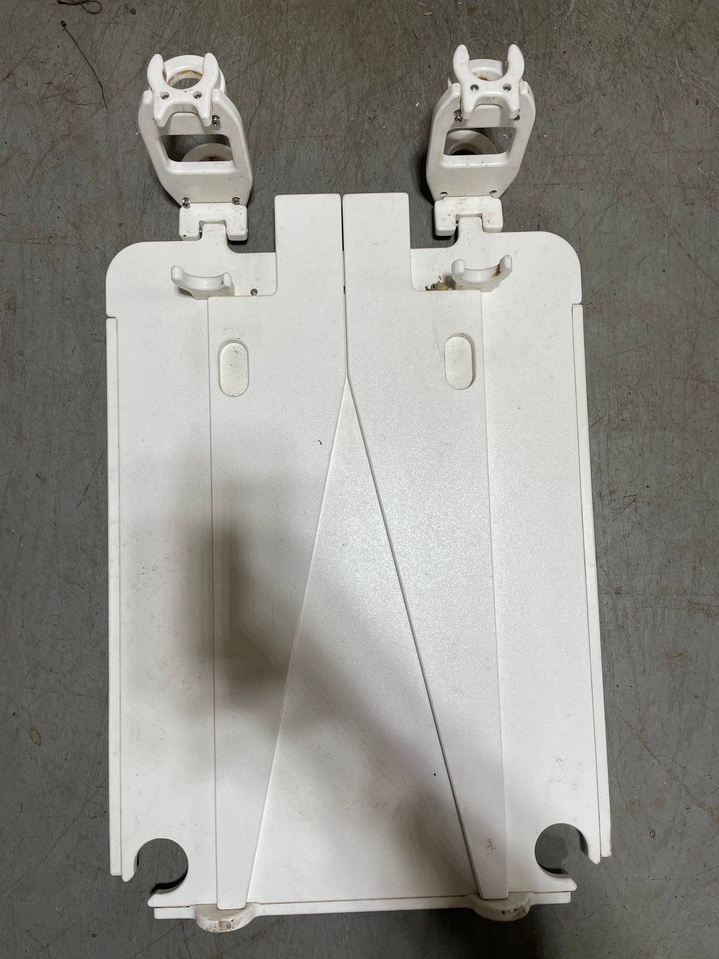 White plastic bracket on a gray surface
