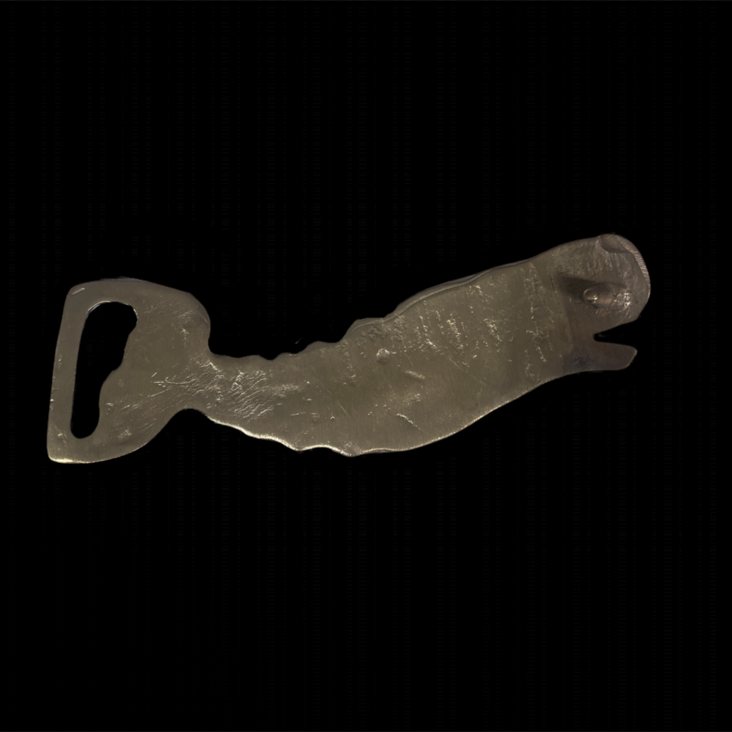 Metallic bottle opener shaped like a dog on a black background