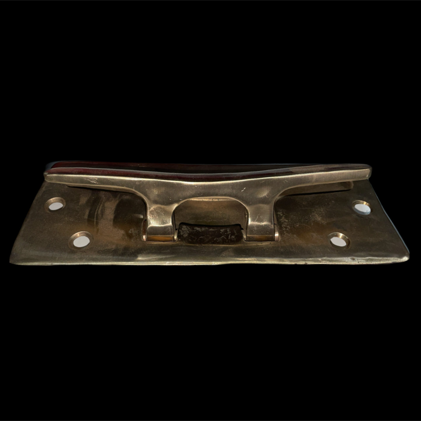 Metal bracket with four screws on a black background