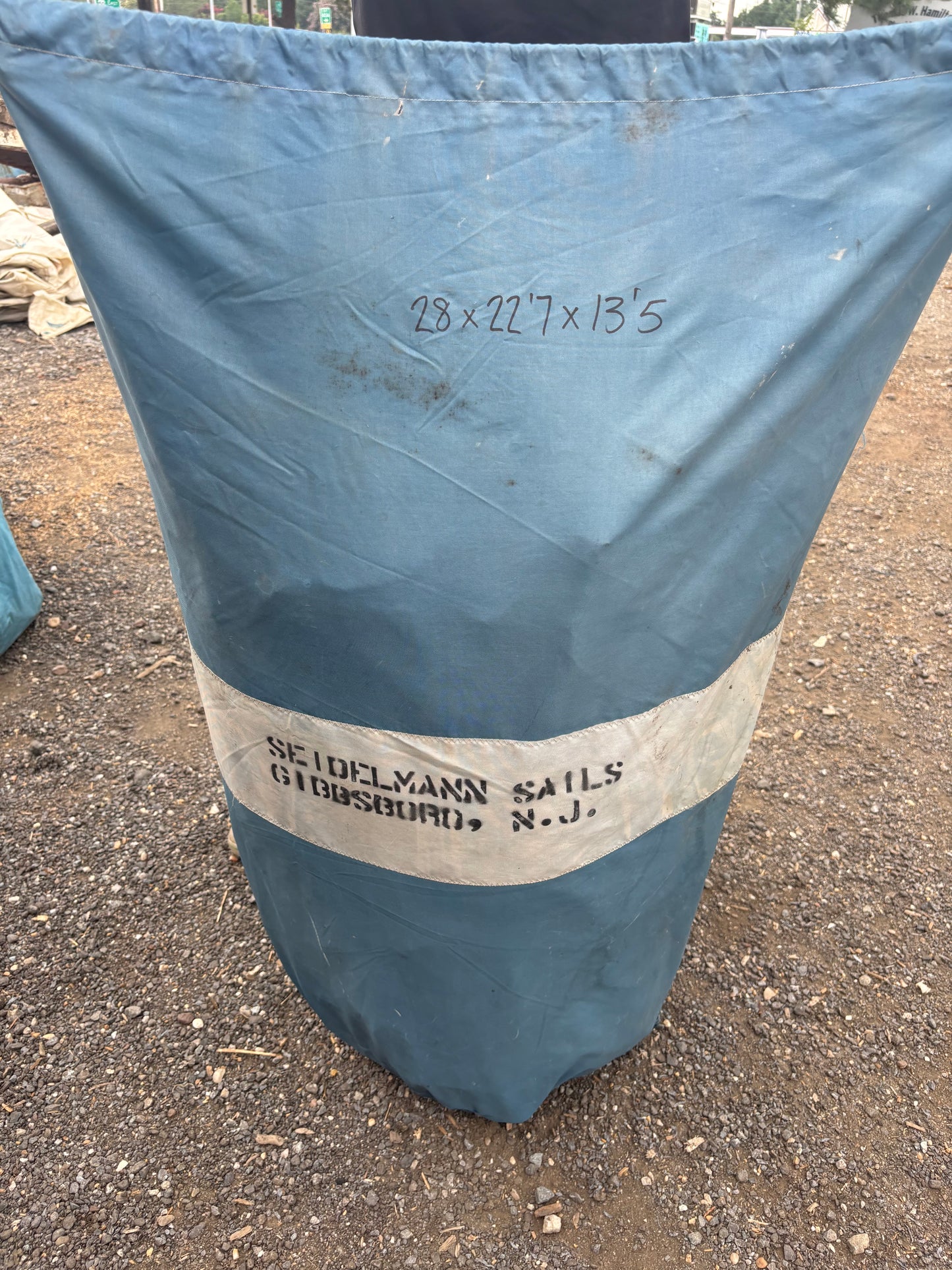 Blue sail with a label on a concrete surface