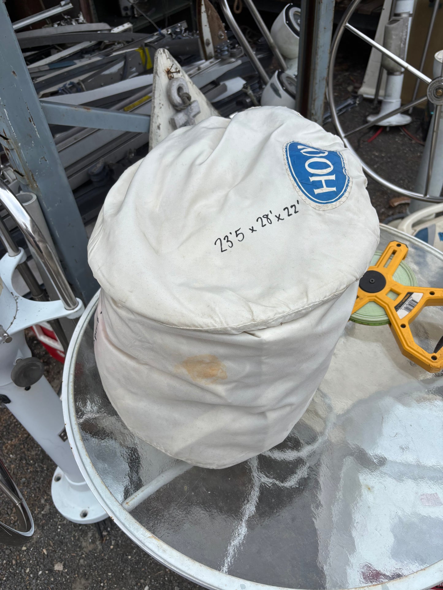 White airbag with a blue logo on a vehicle, surrounded by mechanical parts.