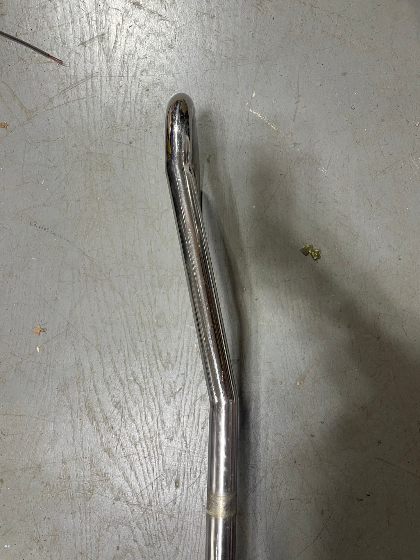 Metallic tool on a scratched metal surface
