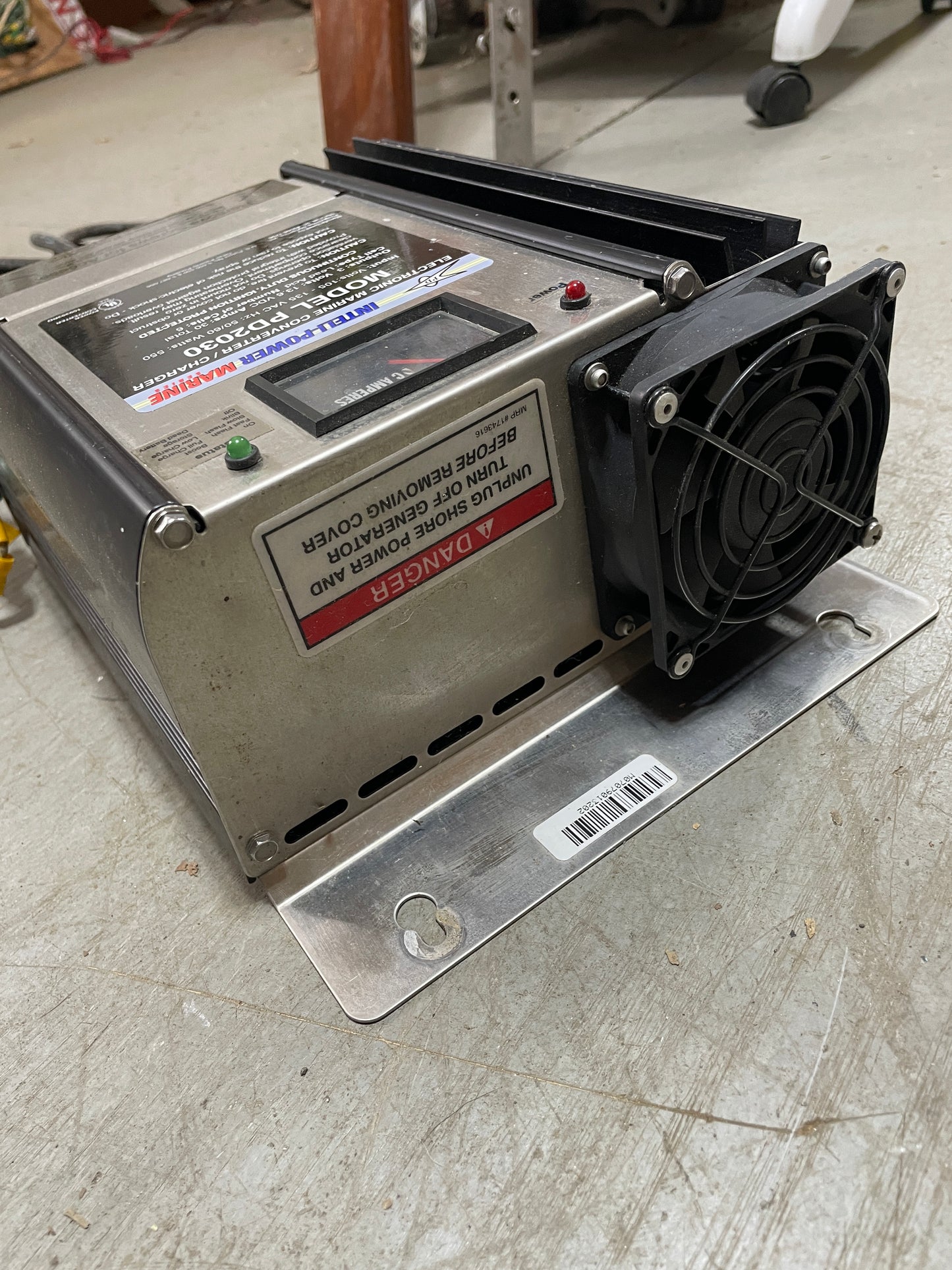 Metal electronic device with fan on a concrete floor