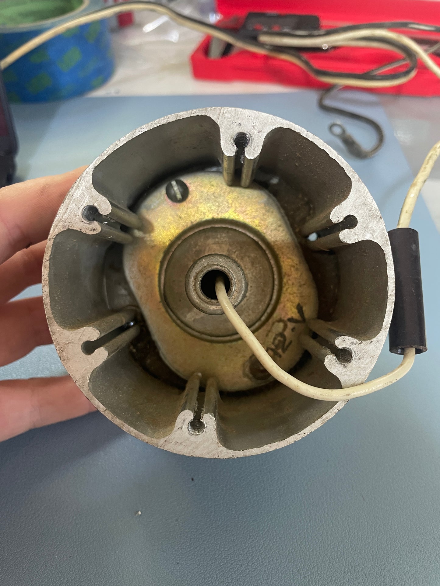 Mechanical component held in a hand with a blurred background