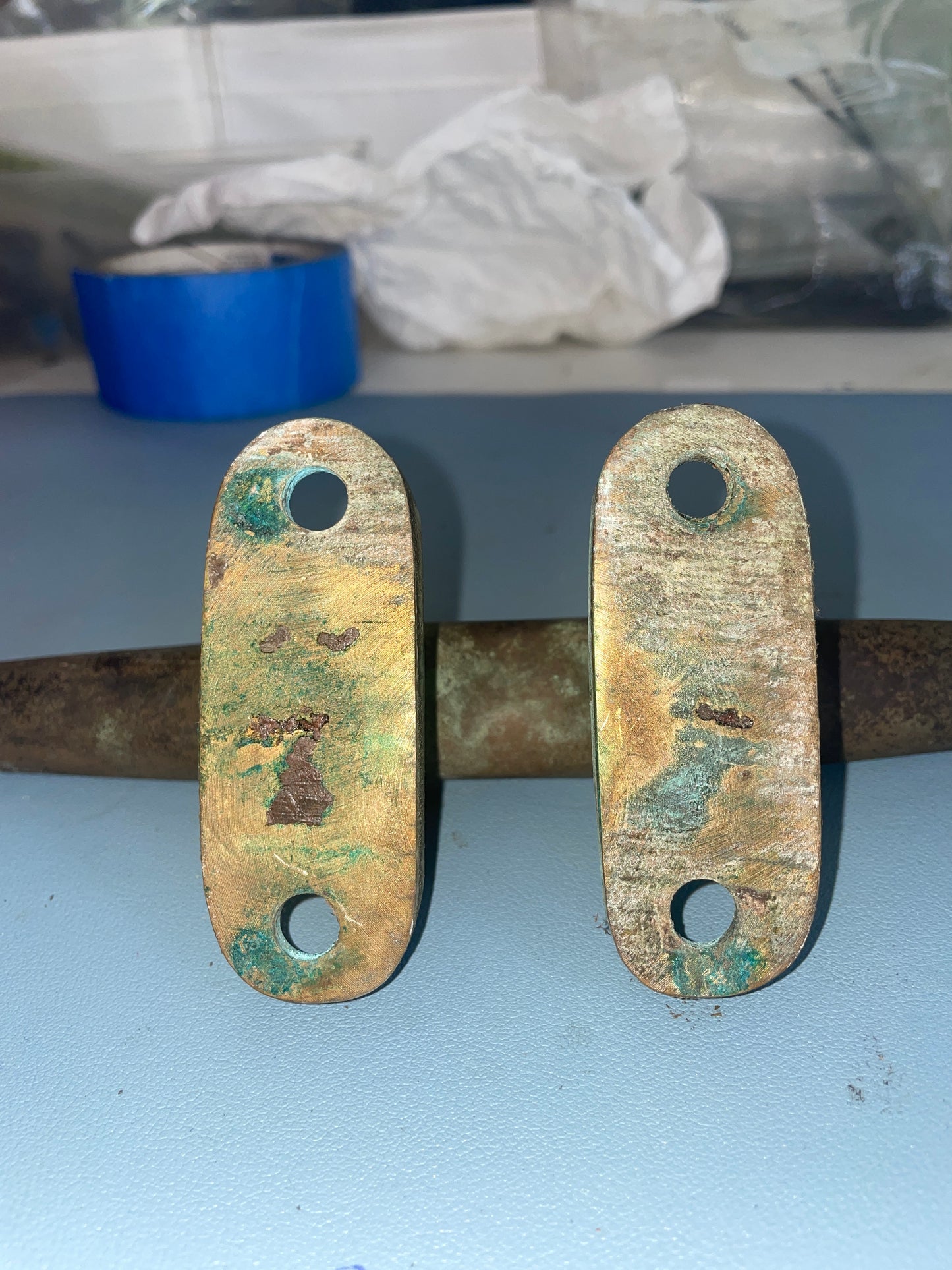Rust-covered metal hinge on a blue background