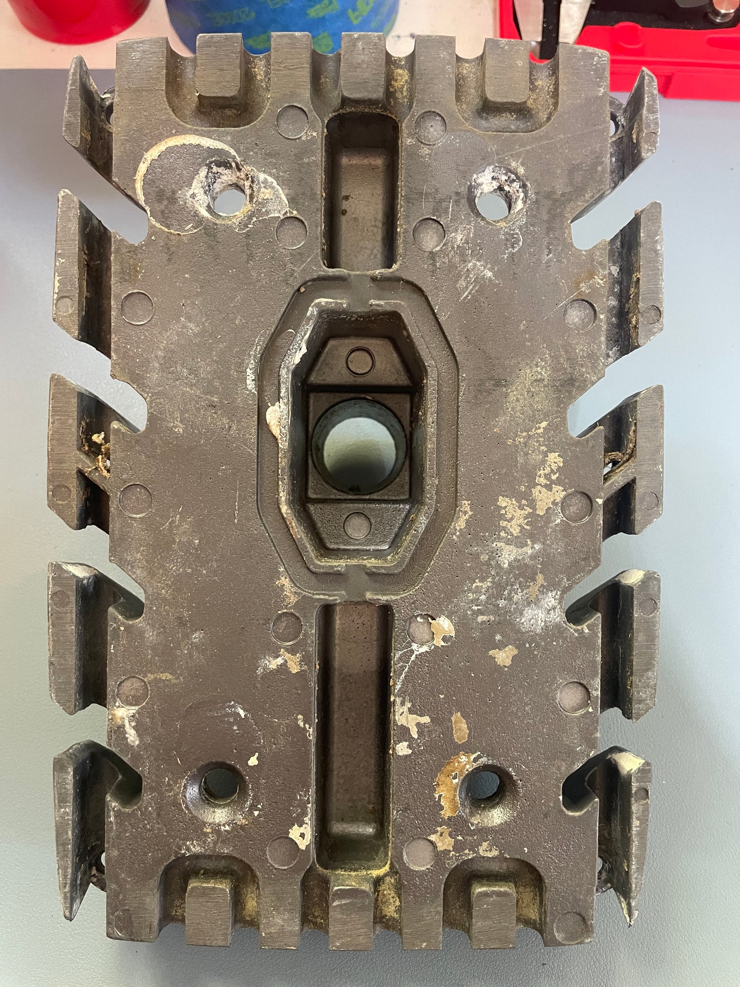 Metallic gear or mechanical component on a gray background